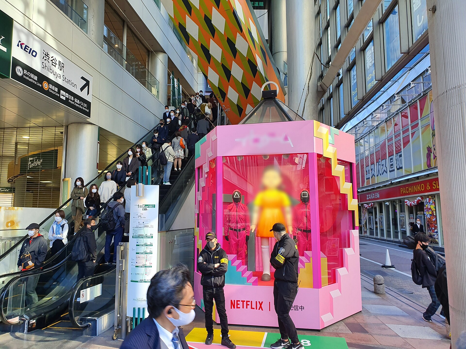 Young-hee doll display with pink guards in Shibuya